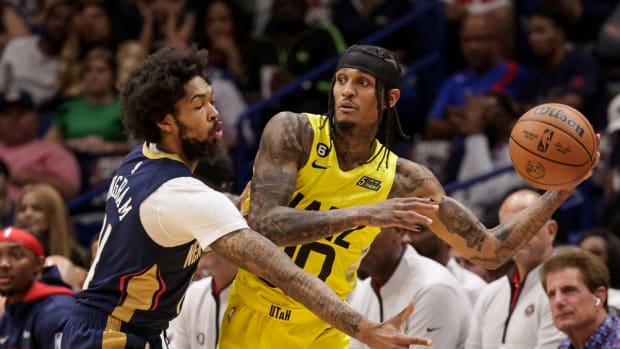 Utah Jazz guard Jordan Clarkson (00) looks to pass the ball against New Orleans Pelicans forward Brandon Ingram (14) during the first half at Smoothie King Center.